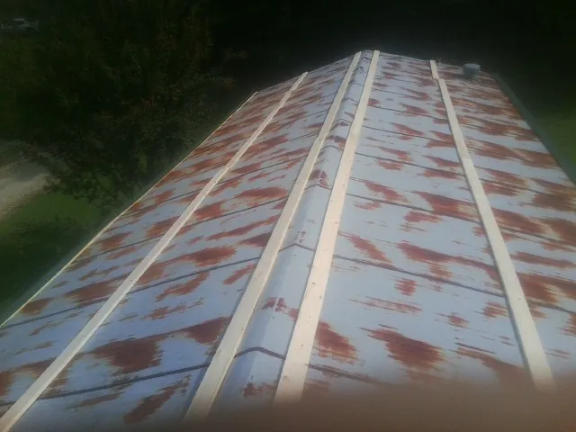 Rusted metal roof panels with new wood purlins before replacement — Storm Damage Roof Repair in Carrolls by Roofing Brothers