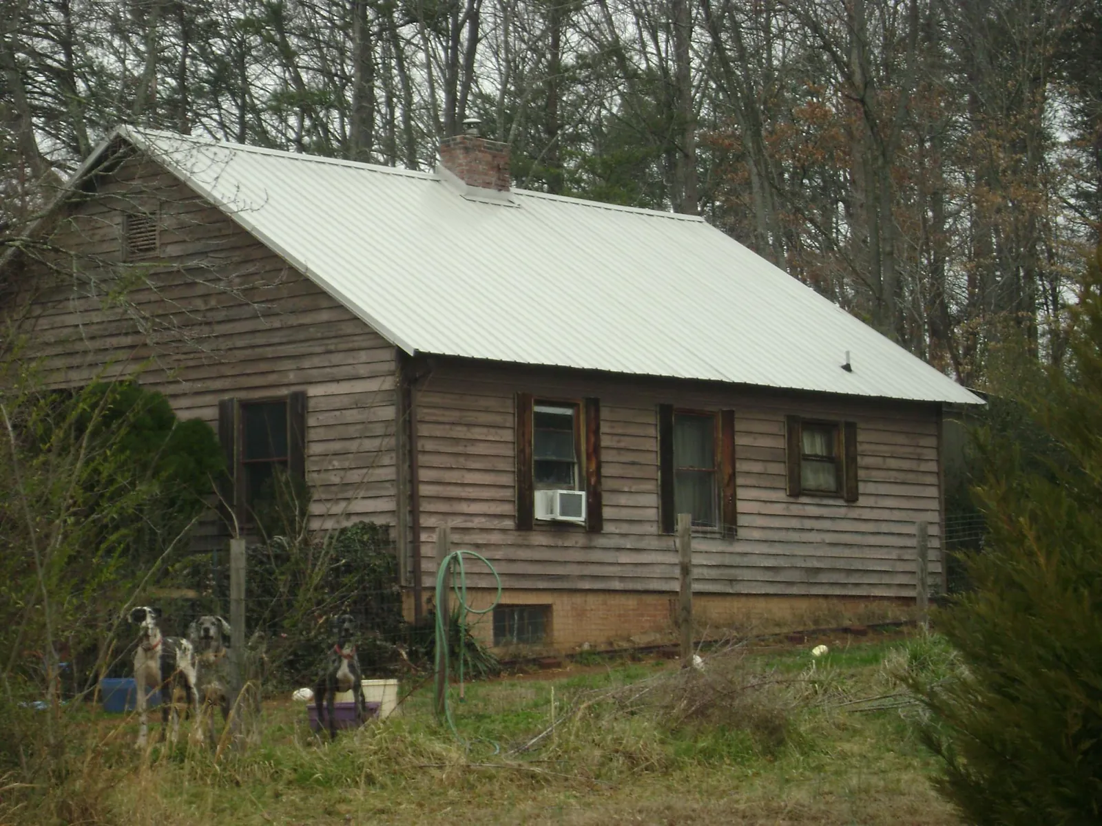 White metal roof on an old wood sided farmhouse, from a Metal Roof Installation job in Carrolls